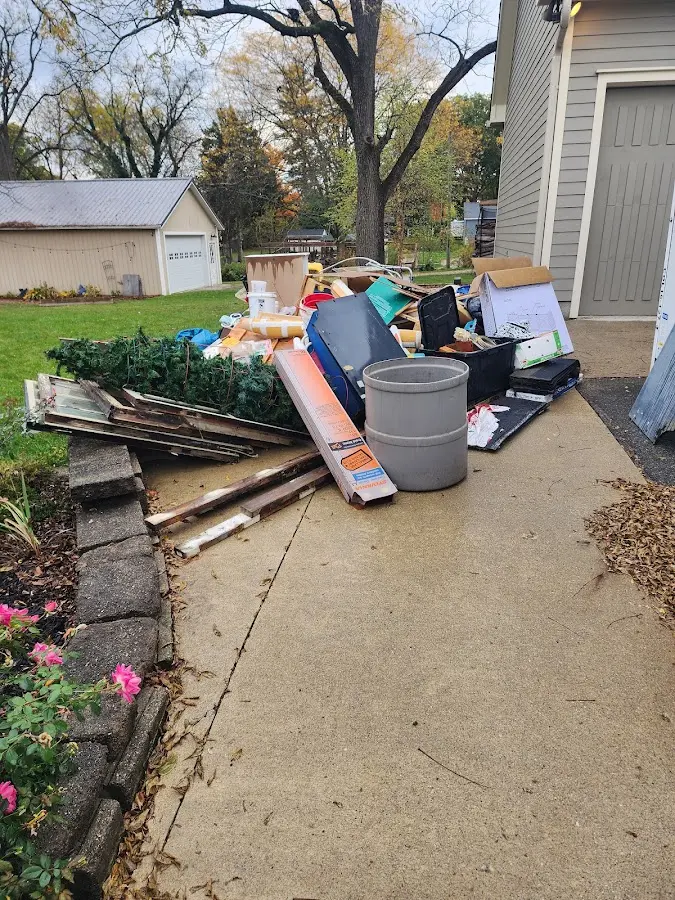 Dumpster being loaded with debris for Roofing Dumpster Rental in Nolensville